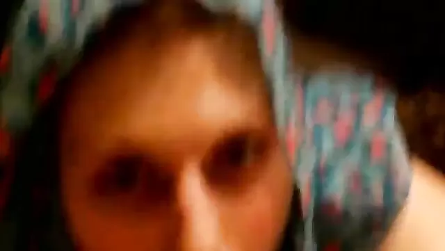 A girl in a scarf gently sucks a man's cock